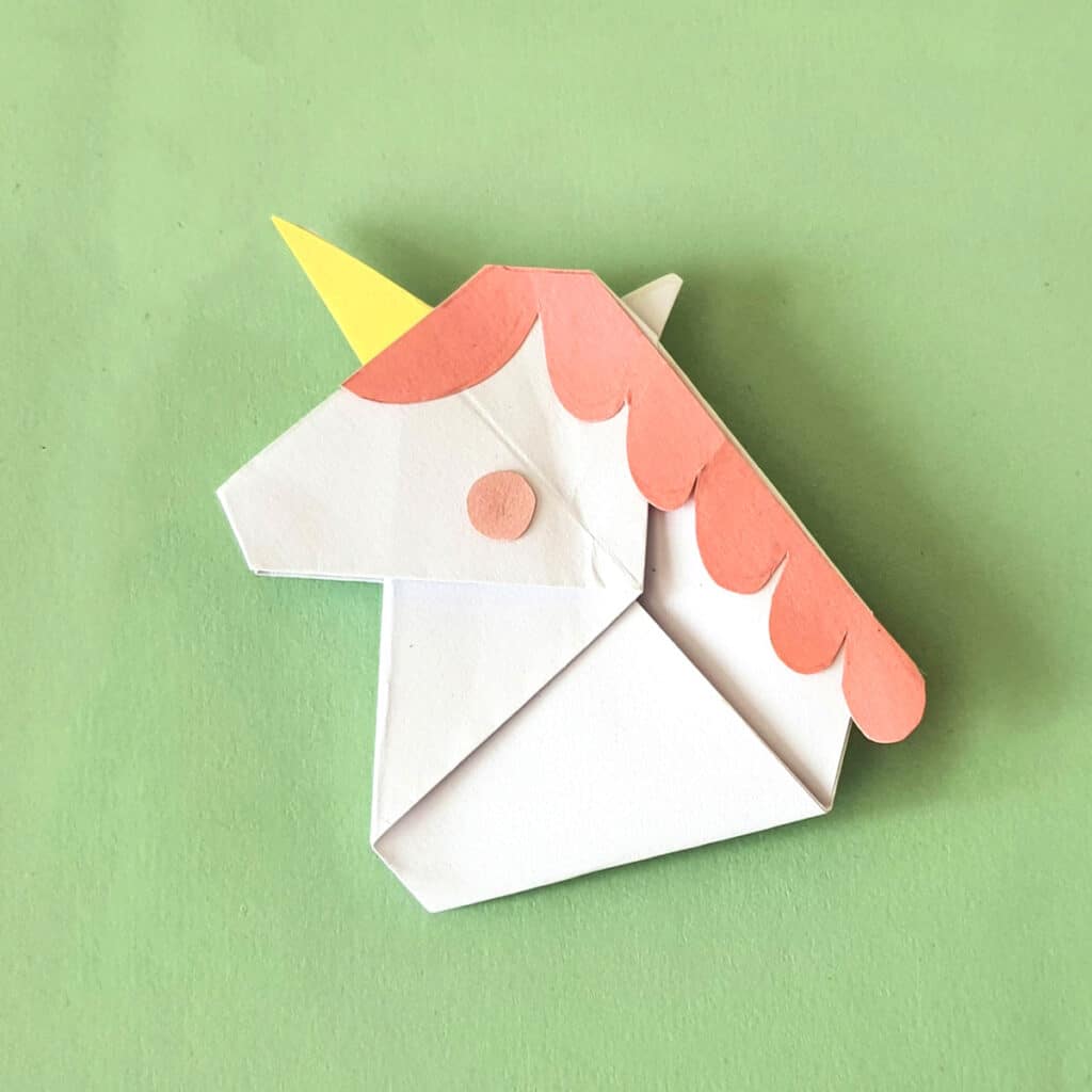 gluing the accents on the origami unicorn 